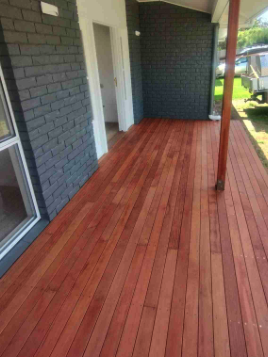 Stained porch decking against a Richmond brick rowhouse