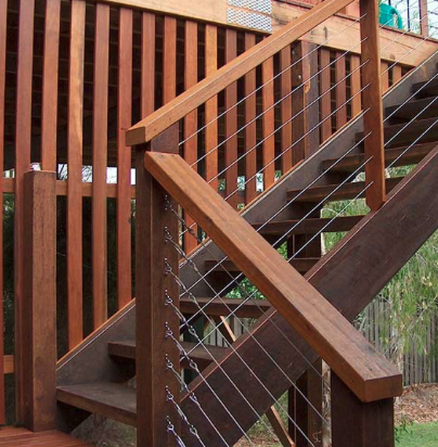 Stained hardwood stairs with cable railing in Glen Allen